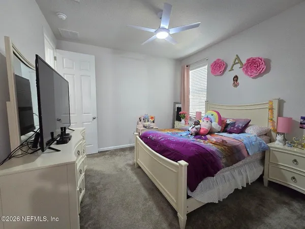 a bed room with a bed and a chandelier