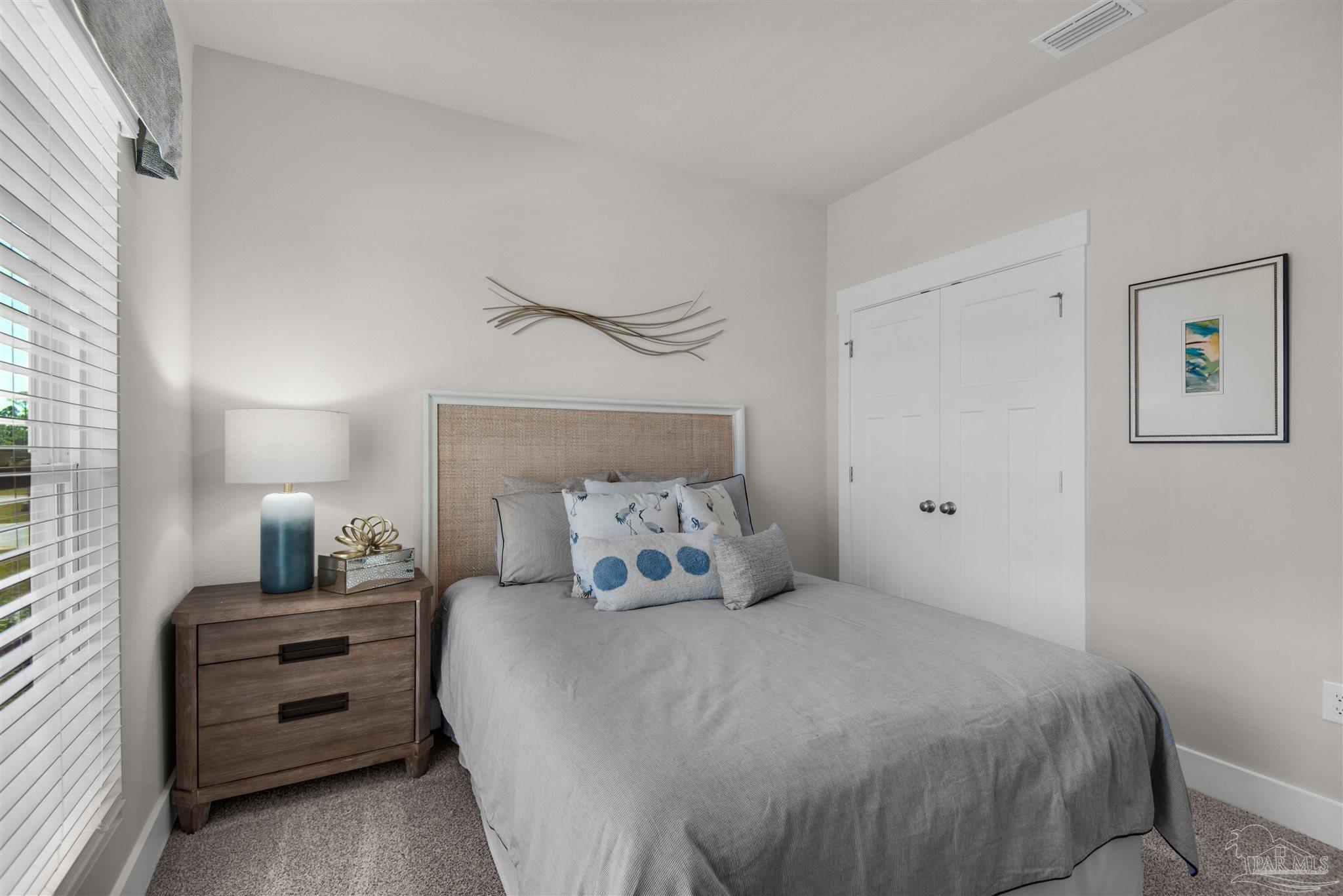 3411 Crossvine Road Cantonment, FL 32533 - Photo 11 of 45 a bedroom with a bed and a night stand