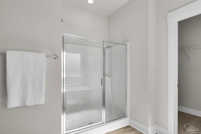 a bathroom with a glass shower door