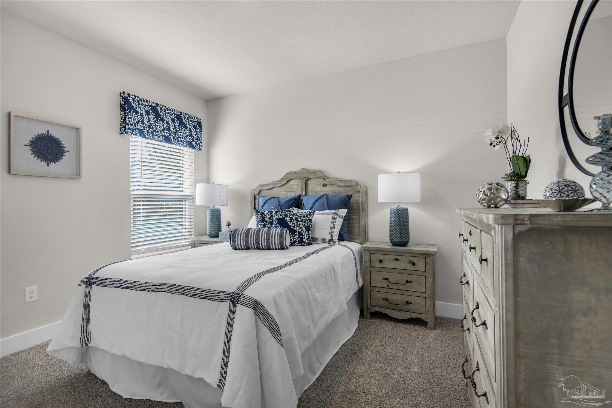 3411 Crossvine Road Cantonment, FL 32533 - Photo 5 of 45 a bedroom with a bed next to a window and a chandelier