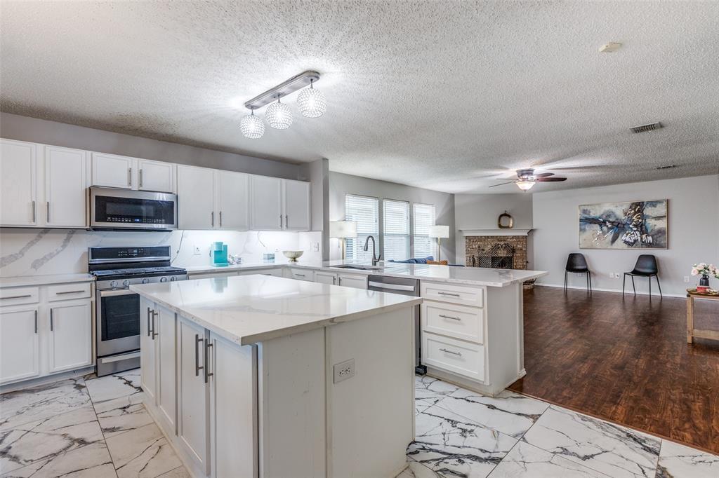 1425 Ridgecrest Drive Little Elm, TX 75068 - Photo 1 of 27 a kitchen with white cabinets appliances and sink