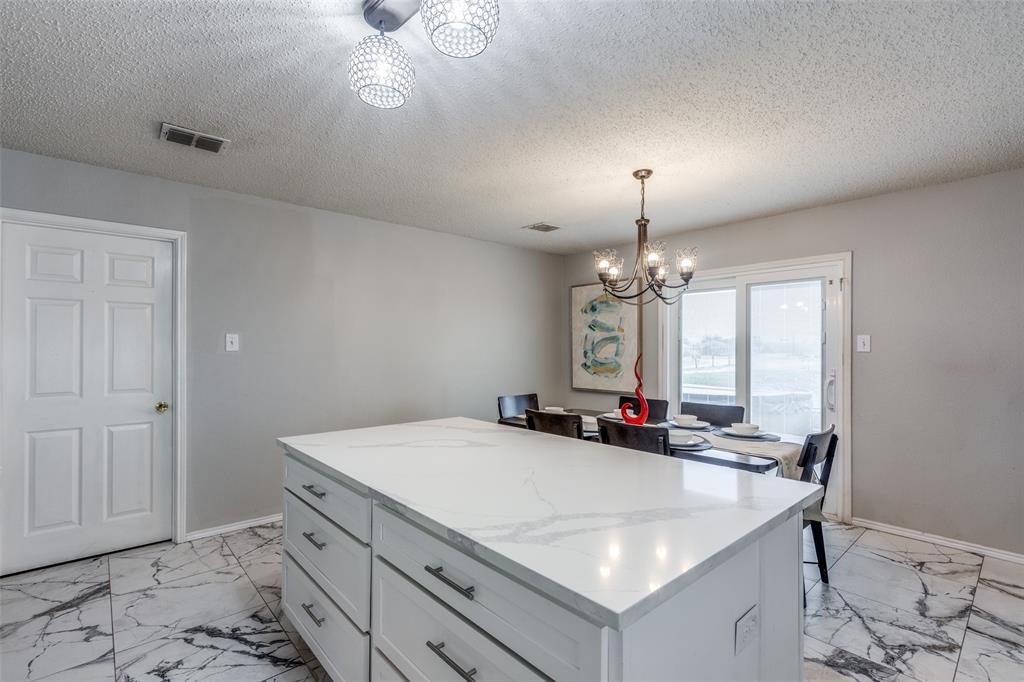 1425 Ridgecrest Drive Little Elm, TX 75068 - Photo 12 of 27 a kitchen with a stove a sink and a refrigerator
