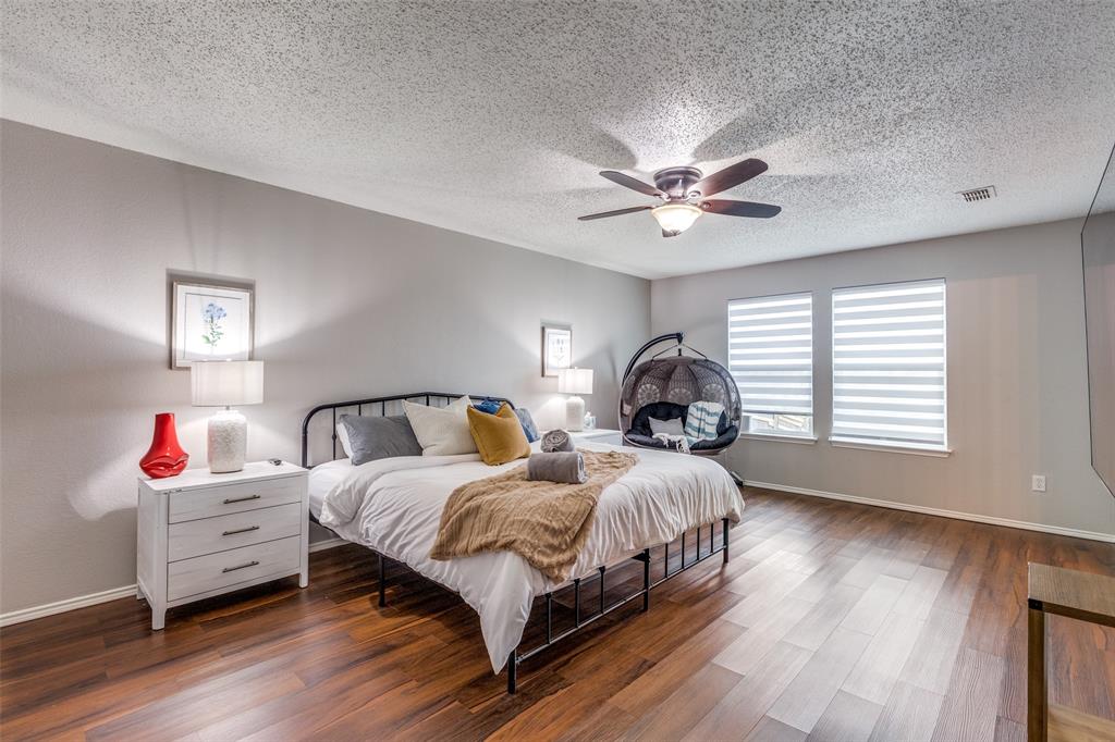 1425 Ridgecrest Drive Little Elm, TX 75068 - Photo 15 of 27 a bedroom with a bed and a chandelier