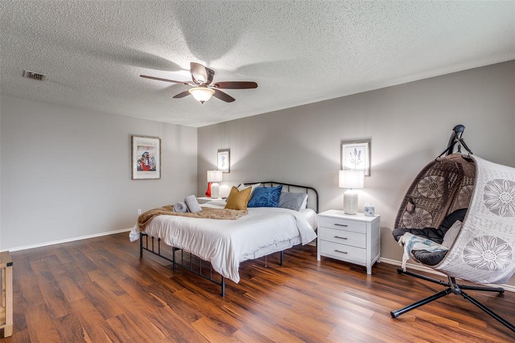 1425 Ridgecrest Drive Little Elm, TX 75068 - Photo 17 of 27 a bedroom with a bed a chandelier and a window