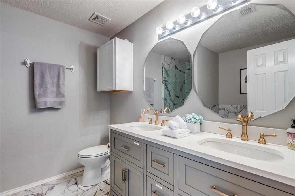 1425 Ridgecrest Drive Little Elm, TX 75068 - Photo 18 of 27 a bathroom with a toilet sink and mirror