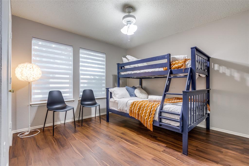1425 Ridgecrest Drive Little Elm, TX 75068 - Photo 20 of 27 a bedroom with furniture and a wooden floor