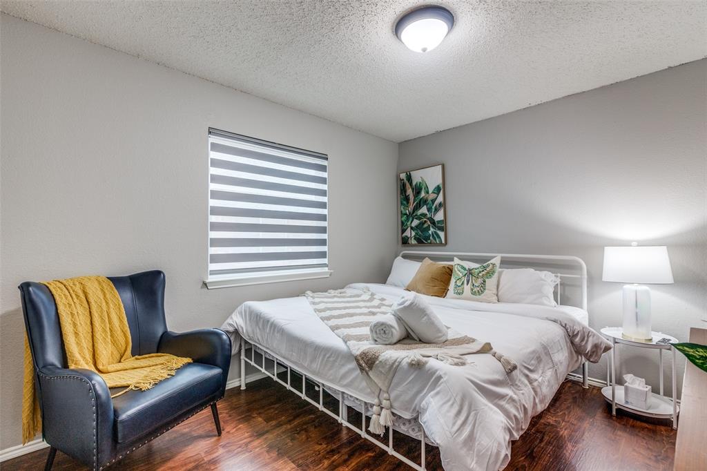 1425 Ridgecrest Drive Little Elm, TX 75068 - Photo 21 of 27 a bedroom with a bed and wooden floor