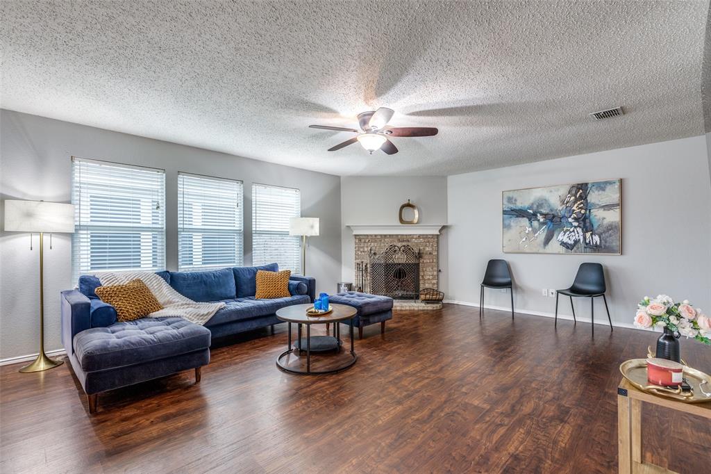 1425 Ridgecrest Drive Little Elm, TX 75068 - Photo 7 of 27 a living room with furniture fireplace and a large window