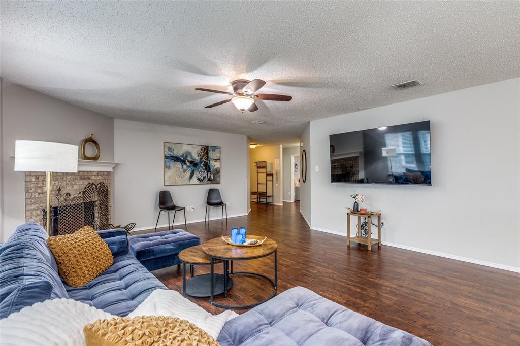 1425 Ridgecrest Drive Little Elm, TX 75068 - Photo 8 of 27 a living room with furniture fireplace and a flat screen tv