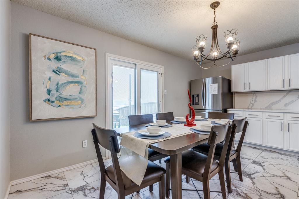 1425 Ridgecrest Drive Little Elm, TX 75068 - Photo 10 of 27 a view of a dining room with furniture window and wooden floor