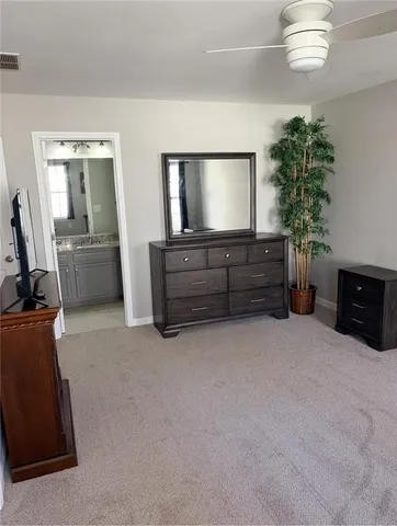 a bathroom with a granite countertop toilet sink and mirror