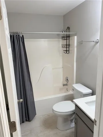 a white toilet sitting next to a bathroom sink