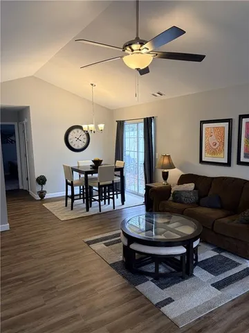 a living room with furniture and a chandelier