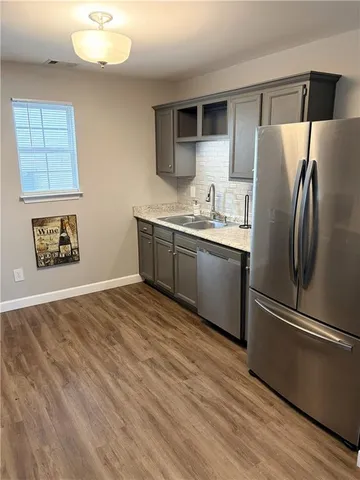 a kitchen with stainless steel appliances granite countertop a refrigerator sink and stove