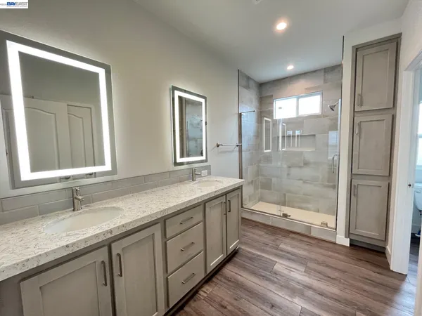 a bathroom with a granite countertop sink mirror and double