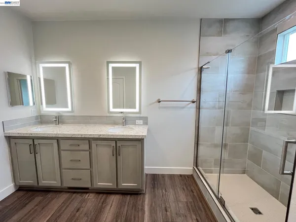 a bathroom with a granite countertop sink toilet and shower