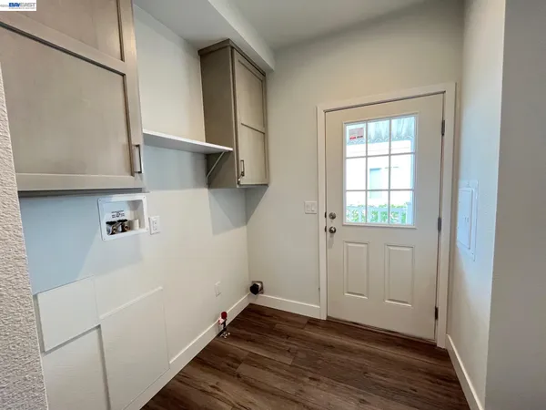 a view of storage and utility room with wooden floor