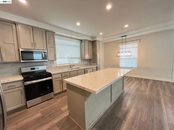 a large kitchen with wooden floor