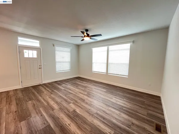 wooden floor in an empty room with a window