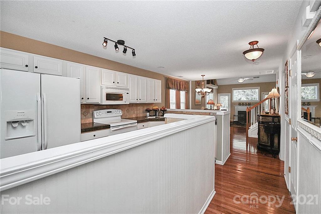 16844 Timber Crossing Road, Unit 2111 Charlotte, NC 28213 - Photo 2 of 33 a kitchen with stainless steel appliances a refrigerator sink and cabinets