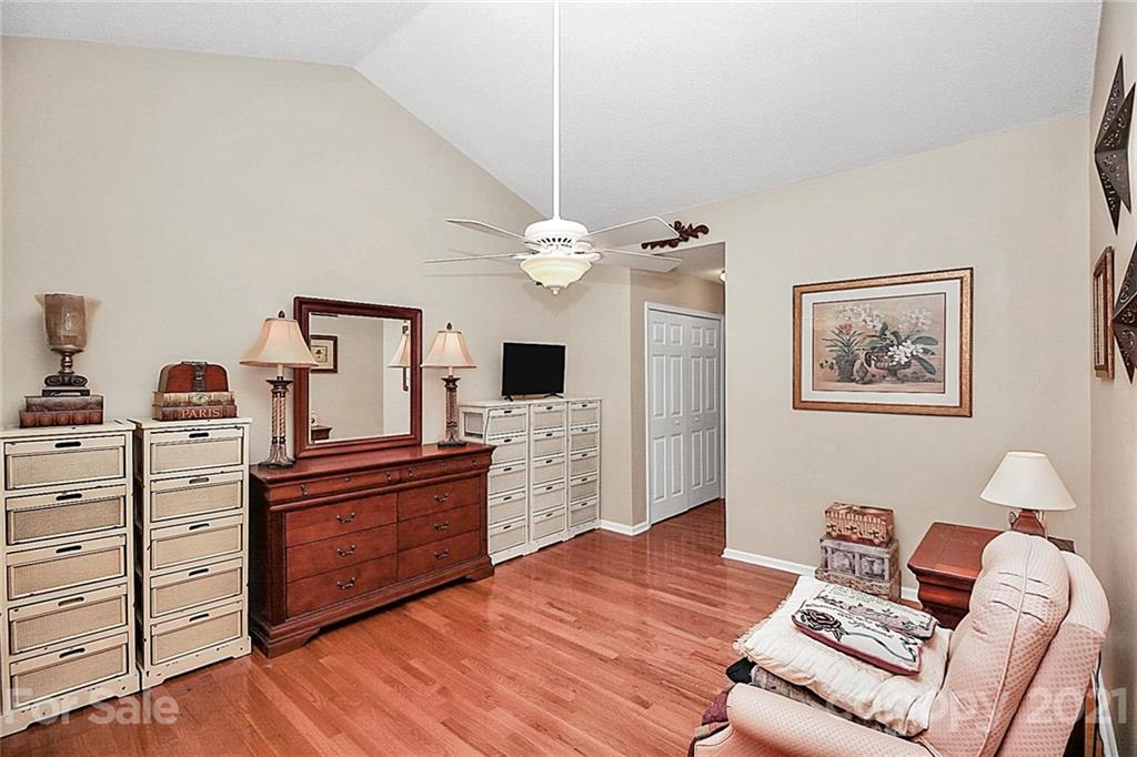 16844 Timber Crossing Road, Unit 2111 Charlotte, NC 28213 - Photo 11 of 33 a living room with furniture and wooden floor