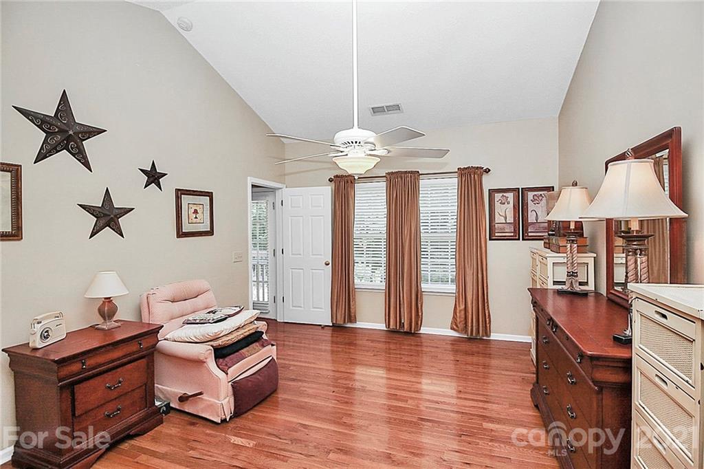 16844 Timber Crossing Road, Unit 2111 Charlotte, NC 28213 - Photo 12 of 33 a living room with furniture and a chandelier