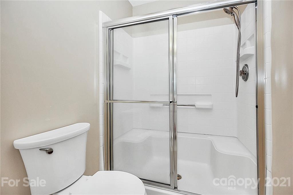 16844 Timber Crossing Road, Unit 2111 Charlotte, NC 28213 - Photo 14 of 33 a bathroom with a shower and a toilet