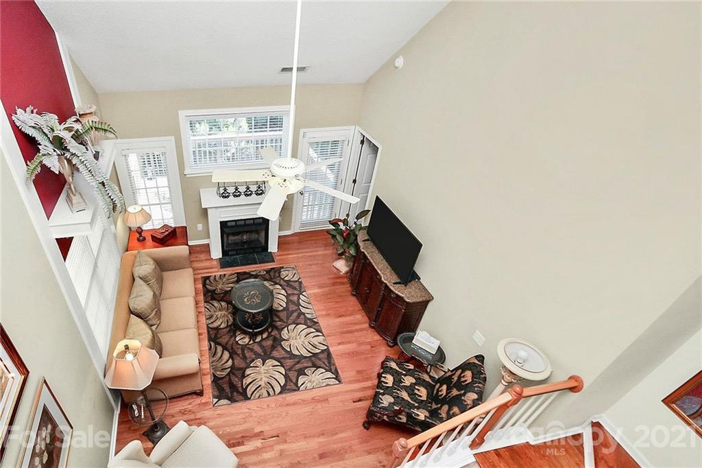 16844 Timber Crossing Road, Unit 2111 Charlotte, NC 28213 - Photo 15 of 33 a living room with furniture a fireplace and a flat screen tv