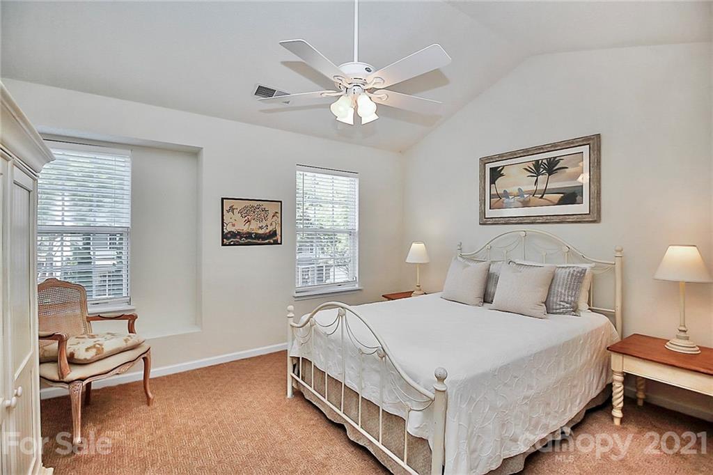 16844 Timber Crossing Road, Unit 2111 Charlotte, NC 28213 - Photo 17 of 33 a bedroom with a bed and a chandelier