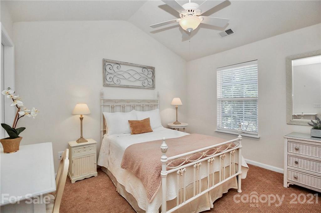 16844 Timber Crossing Road, Unit 2111 Charlotte, NC 28213 - Photo 18 of 33 a bedroom with a bed a lamp and a window