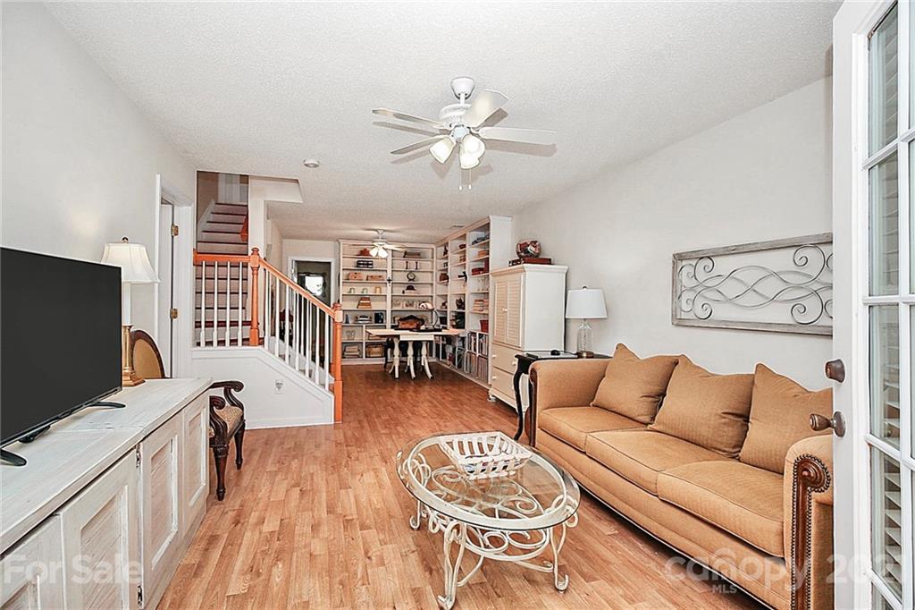 16844 Timber Crossing Road, Unit 2111 Charlotte, NC 28213 - Photo 21 of 33 a living room with furniture and a flat screen tv