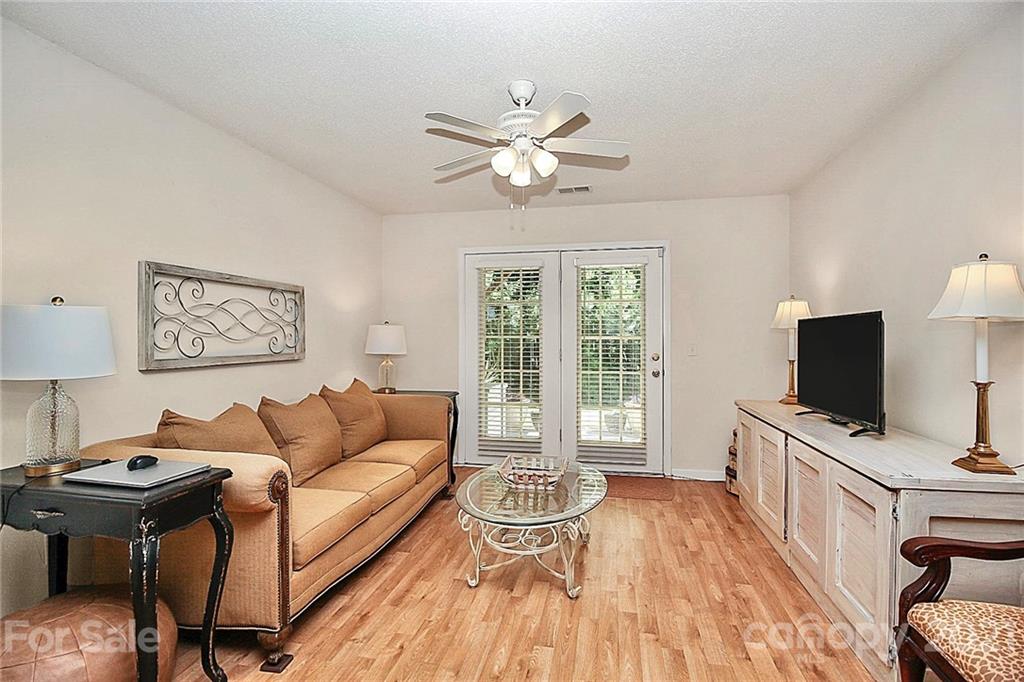 16844 Timber Crossing Road, Unit 2111 Charlotte, NC 28213 - Photo 23 of 33 a living room with furniture and a flat screen tv