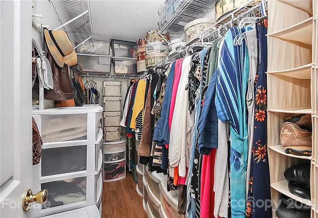 16844 Timber Crossing Road, Unit 2111 Charlotte, NC 28213 - Photo 25 of 33 a view of walk in closet with clothes and shoes