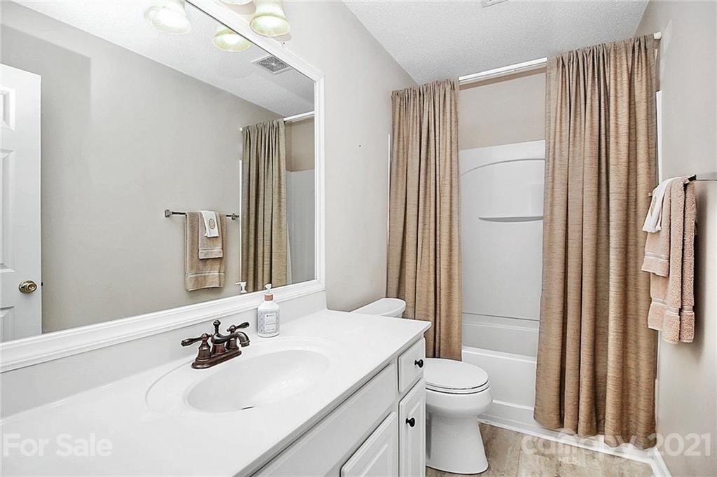 16844 Timber Crossing Road, Unit 2111 Charlotte, NC 28213 - Photo 26 of 33 a bathroom with a sink toilet and shower
