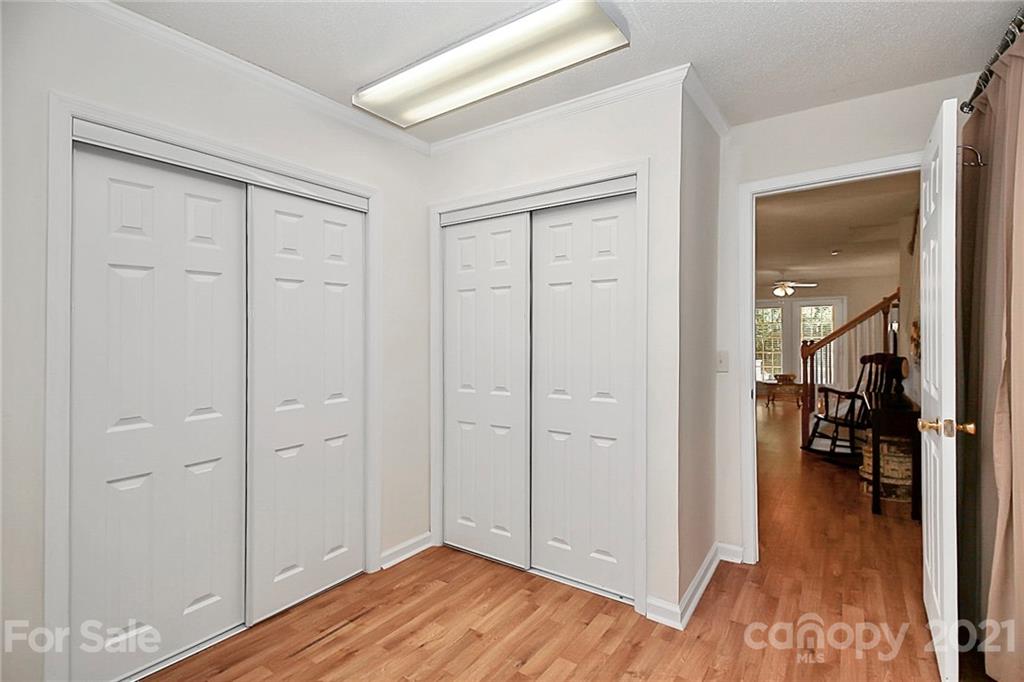 16844 Timber Crossing Road, Unit 2111 Charlotte, NC 28213 - Photo 28 of 33 wooden floor with white walls