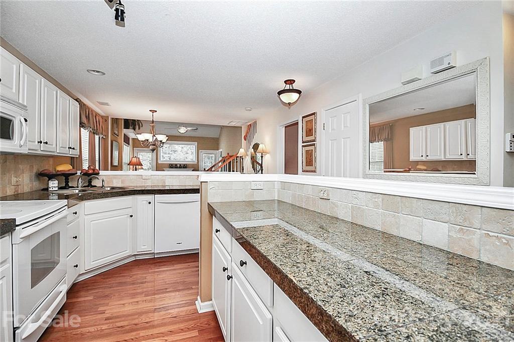 16844 Timber Crossing Road, Unit 2111 Charlotte, NC 28213 - Photo 4 of 33 a kitchen with stainless steel appliances granite countertop a sink stove and cabinets