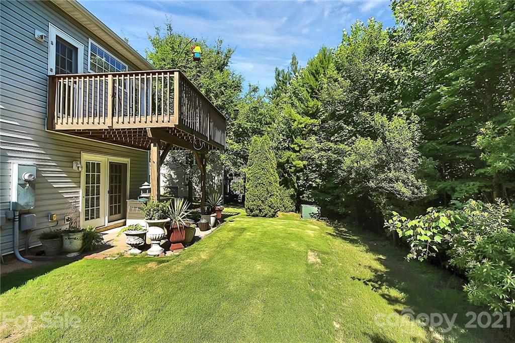 16844 Timber Crossing Road, Unit 2111 Charlotte, NC 28213 - Photo 32 of 33 a view of a house with backyard porch and sitting area