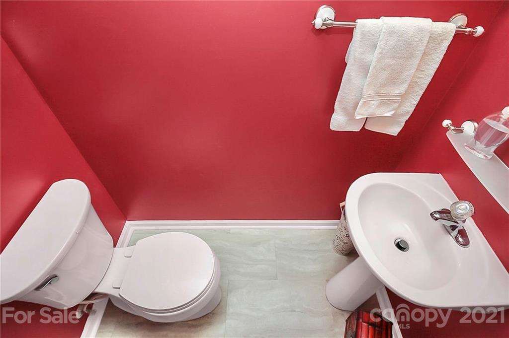 16844 Timber Crossing Road, Unit 2111 Charlotte, NC 28213 - Photo 7 of 33 a bathroom with a toilet and a sink