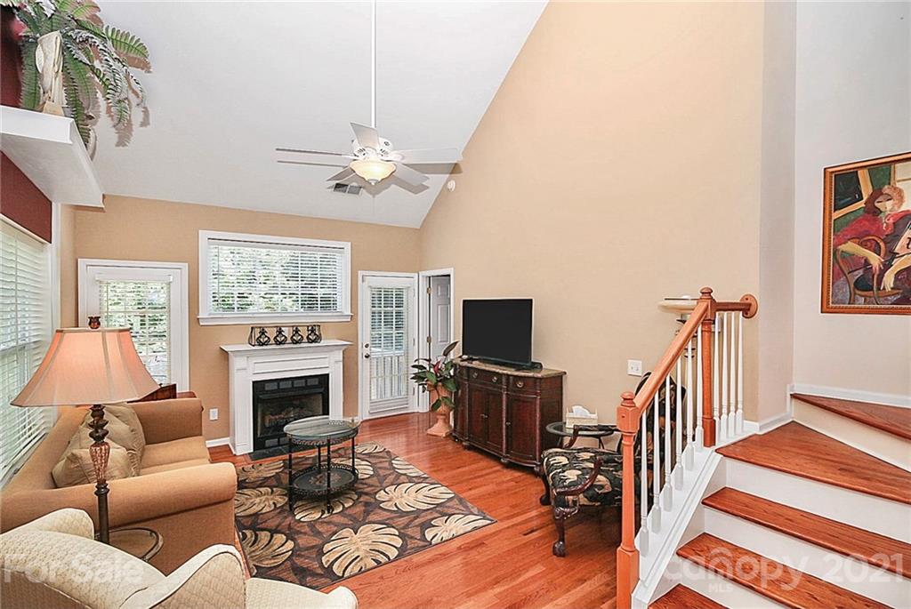 16844 Timber Crossing Road, Unit 2111 Charlotte, NC 28213 - Photo 8 of 33 a living room with furniture a fireplace and a flat screen tv