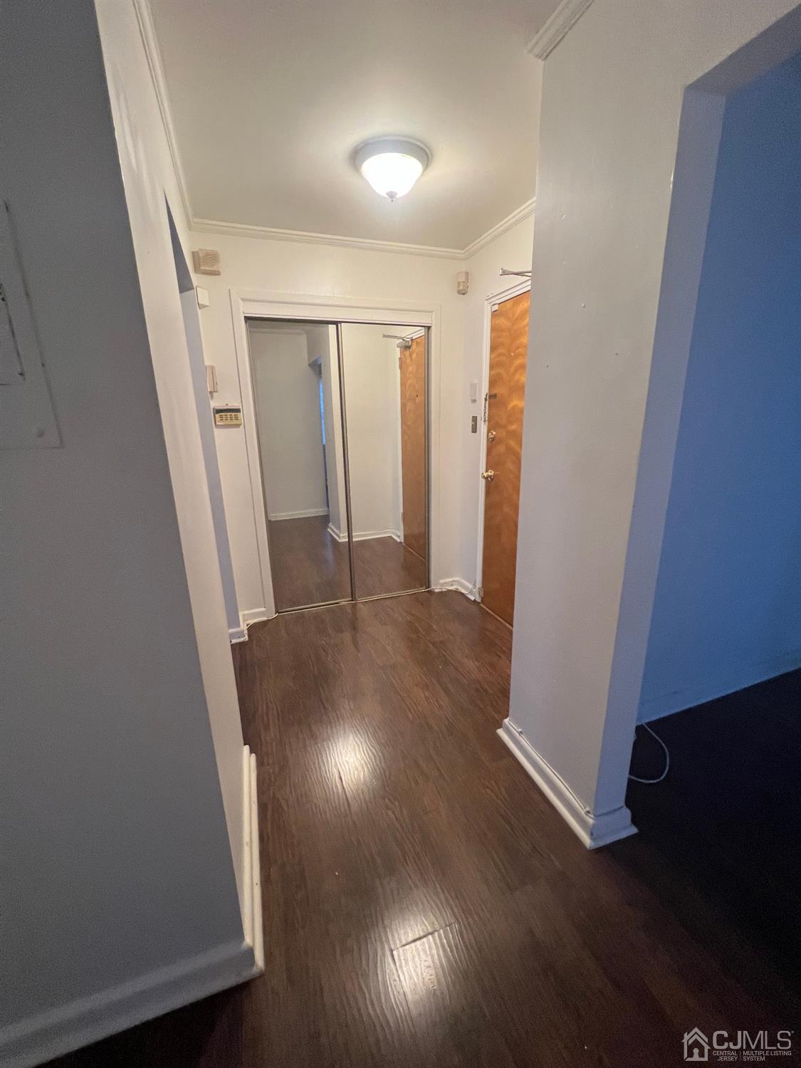C E Front Street, Unit 95 Plainfield, NJ 07062 - Photo 11 of 14 an entryway in a hall with wooden floor