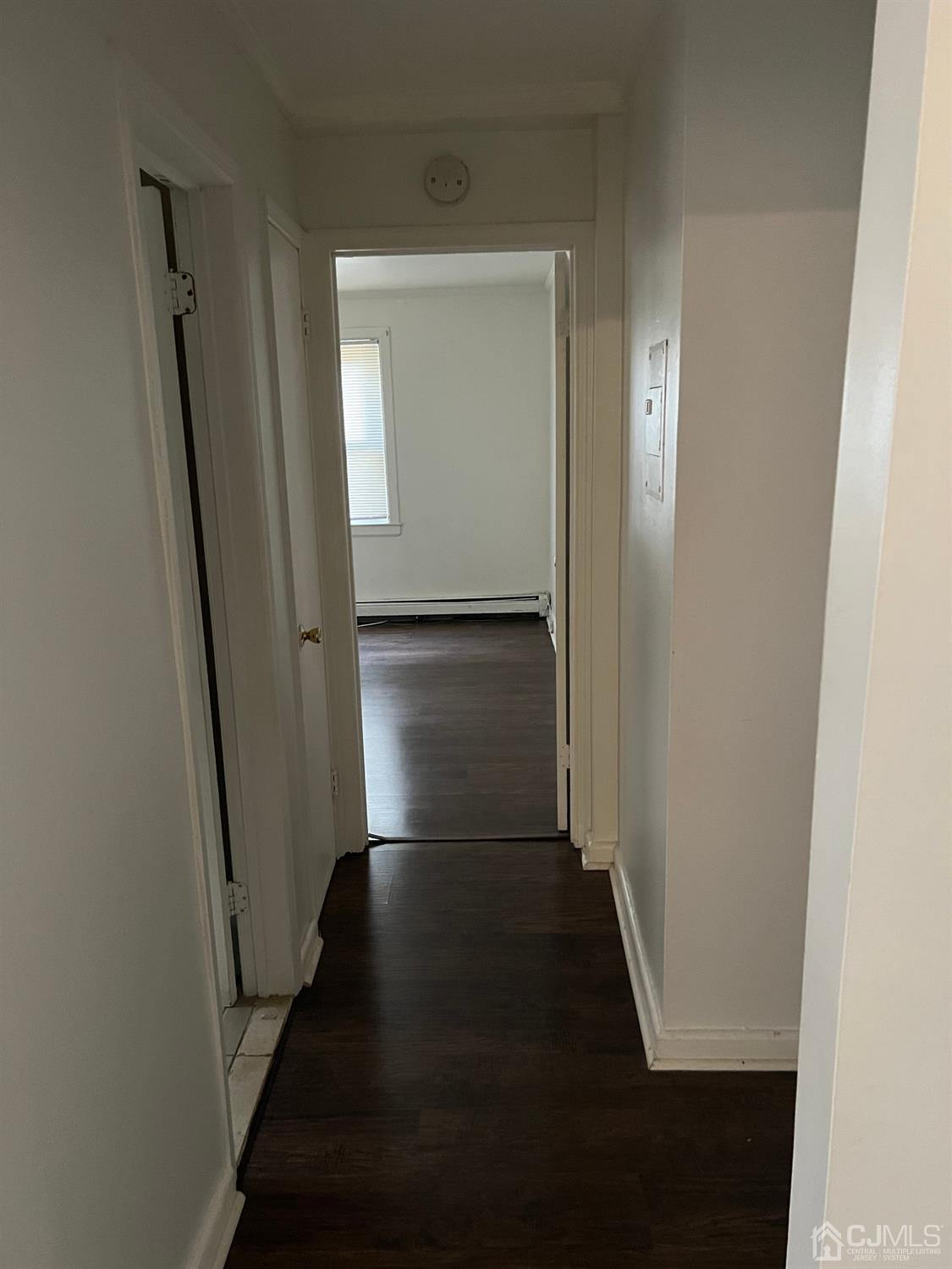 C E Front Street, Unit 95 Plainfield, NJ 07062 - Photo 12 of 14 an empty room with wooden floor