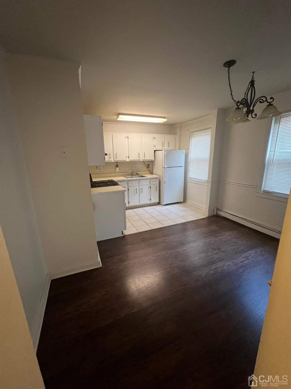 C E Front Street, Unit 95 Plainfield, NJ 07062 - Photo 5 of 14 a view of a kitchen with wooden floor and a sink