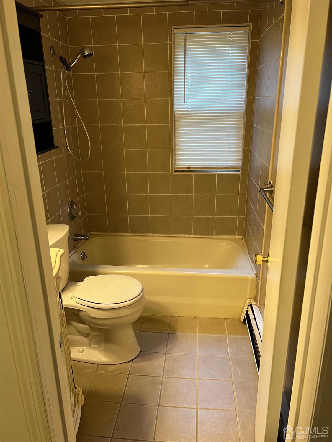 C E Front Street, Unit 95 Plainfield, NJ 07062 - Photo 8 of 14 a bathroom with a toilet and a shower