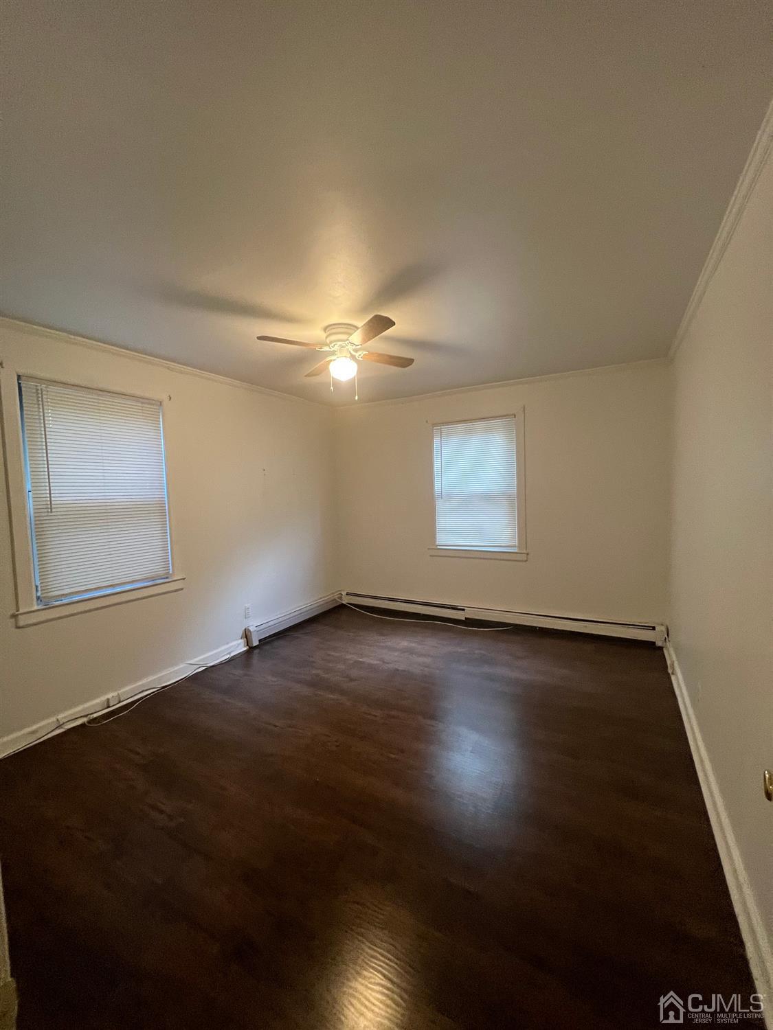 C E Front Street, Unit 95 Plainfield, NJ 07062 - Photo 9 of 14 a view of an empty room with wooden floor and a window
