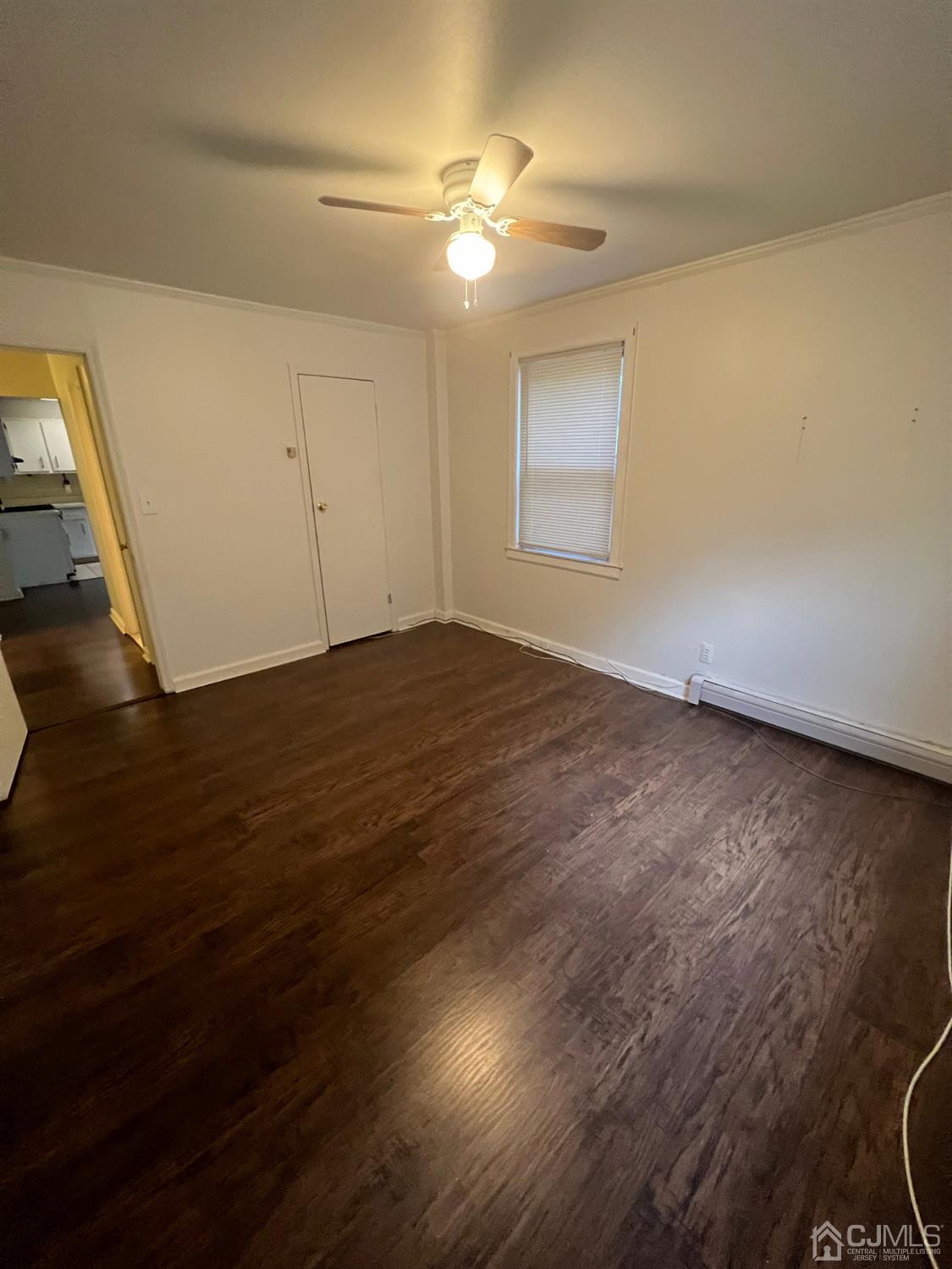 C E Front Street, Unit 95 Plainfield, NJ 07062 - Photo 10 of 14 an empty room with wooden floor and windows