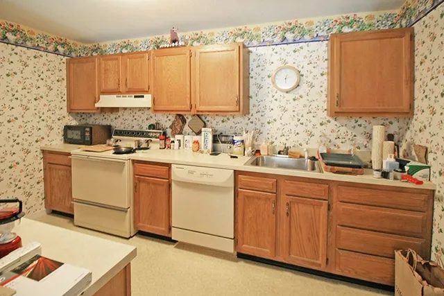 a kitchen with cabinets appliances and a sink