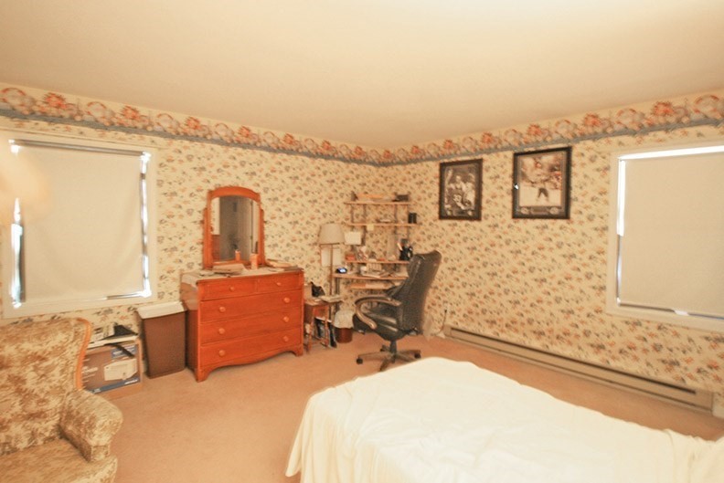 48 Evergreen Road, Unit 306 Northampton, MA 01053 - Photo 6 of 9 a bedroom with a bed and wooden floor