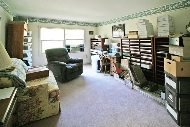 a living room with furniture a flat screen tv and a window