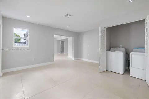 a view of a big room with closet and windows