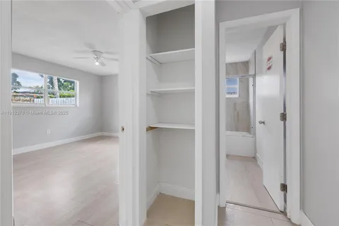 a view of an empty room with a bathroom